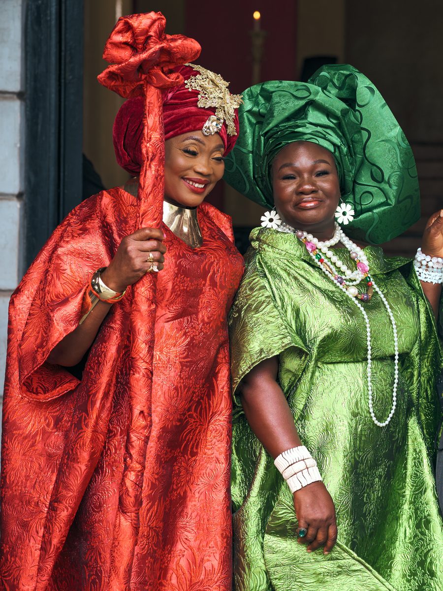 Two of the keepers, in red and green, standing in the doorway of the hall