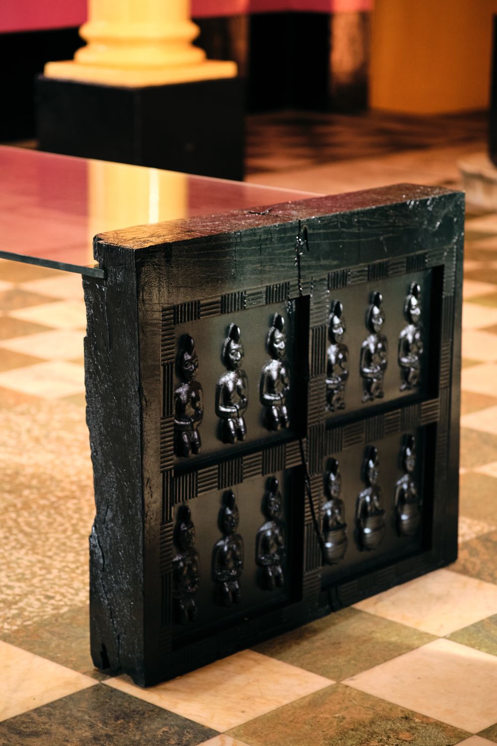 The carved end panel holding the glass top